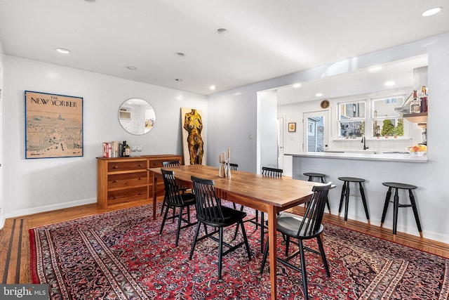 dining room featuring recessed lighting, wood finished floors, and baseboards