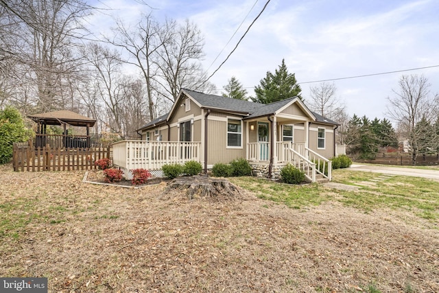 view of front of property featuring a gazebo and a wooden deck