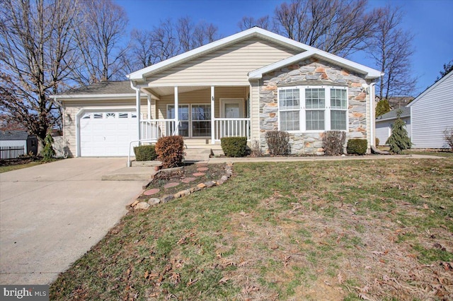 single story home featuring stone siding, covered porch, concrete driveway, a front yard, and an attached garage