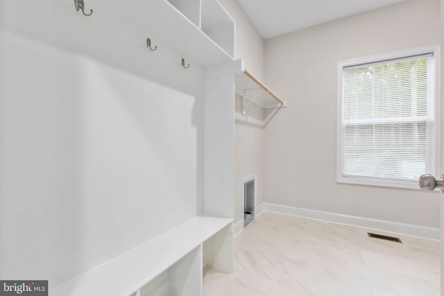 mudroom with visible vents, marble finish floor, and baseboards