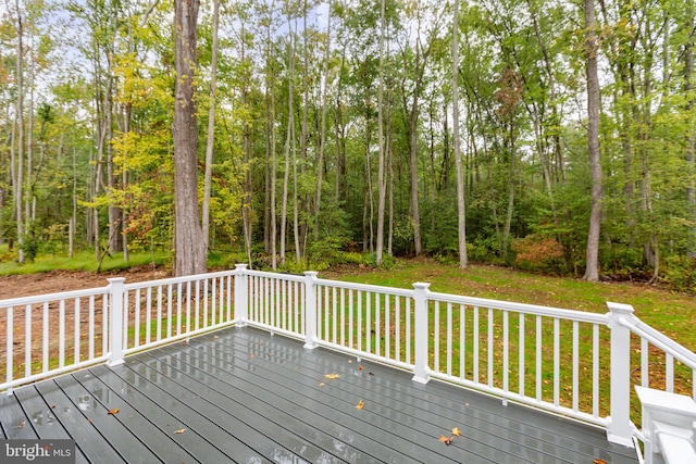 wooden deck with a view of trees