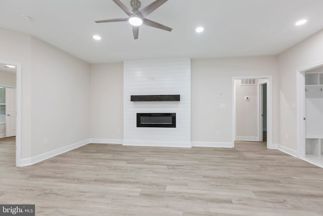 unfurnished living room featuring light wood finished floors, a large fireplace, baseboards, recessed lighting, and a ceiling fan