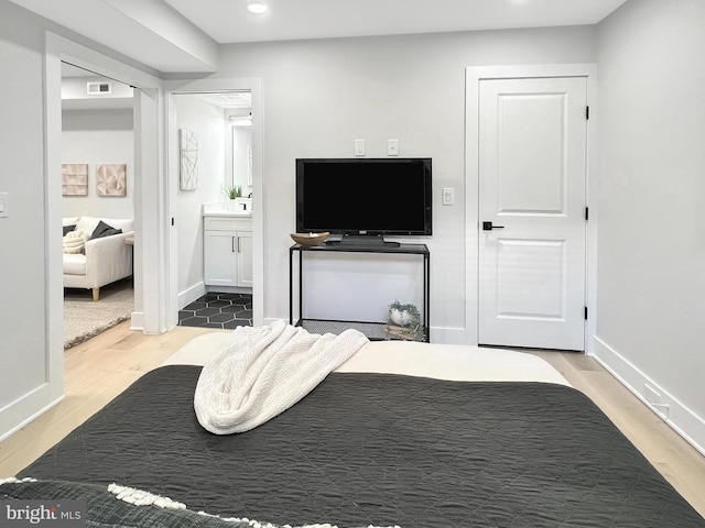 bedroom with visible vents, recessed lighting, baseboards, and wood finished floors