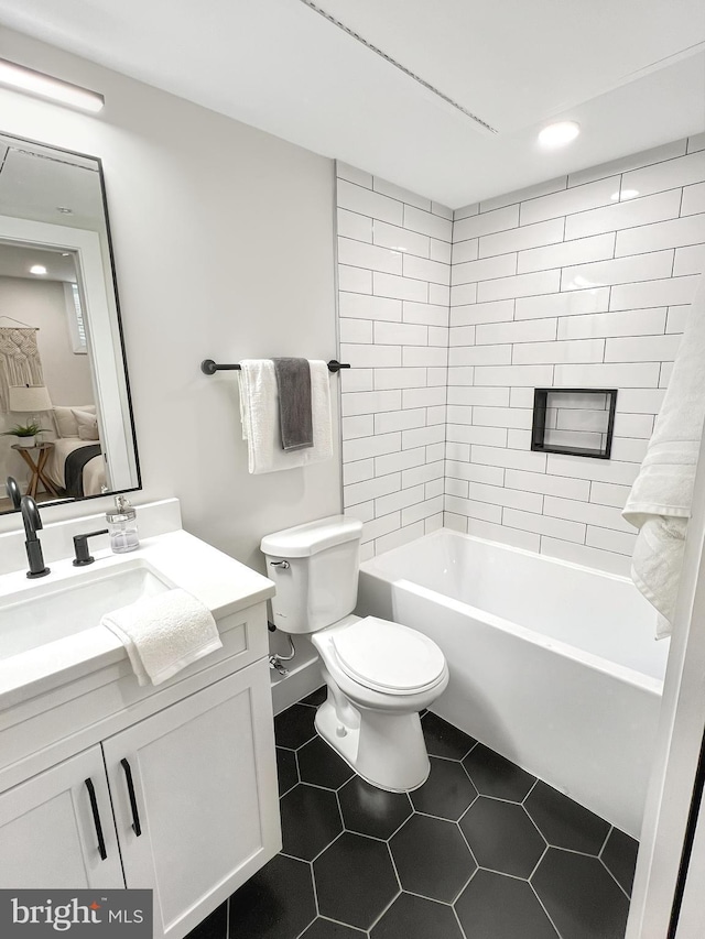 full bath with toilet, shower / tub combination, connected bathroom, tile patterned flooring, and vanity