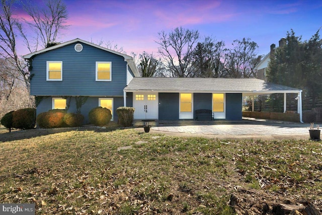 view of front of home featuring a yard and a patio area