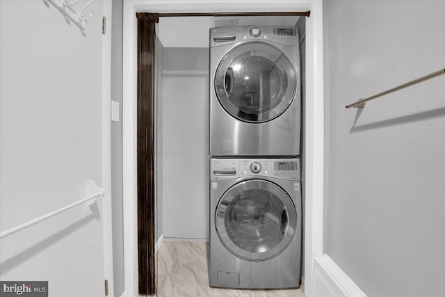 washroom with laundry area, marble finish floor, and stacked washing maching and dryer