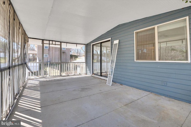 unfurnished sunroom with lofted ceiling