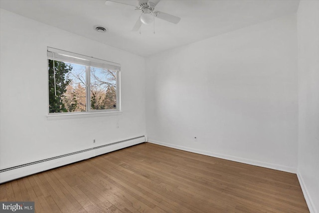 unfurnished room with visible vents, ceiling fan, baseboards, hardwood / wood-style flooring, and a baseboard radiator