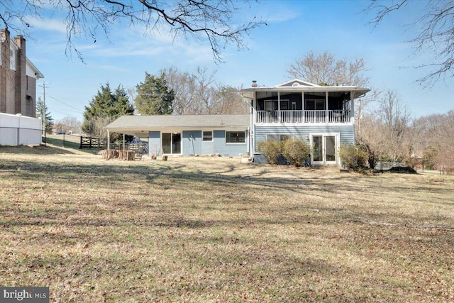 back of house with a chimney, fence, a yard, and a sunroom