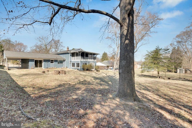 exterior space featuring a carport and a chimney