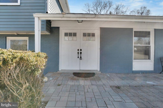 property entrance featuring brick siding