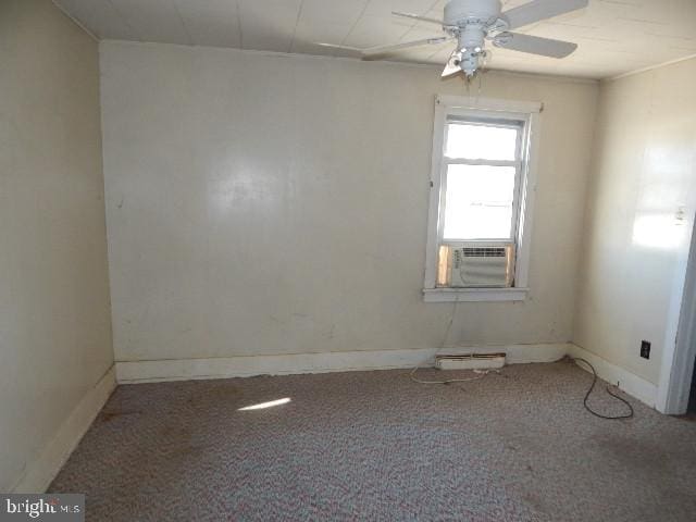 unfurnished room with baseboards, cooling unit, a ceiling fan, and carpet