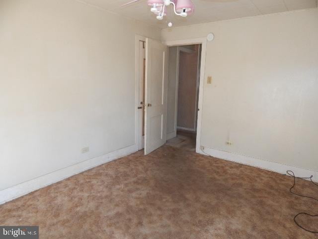 carpeted empty room with baseboards