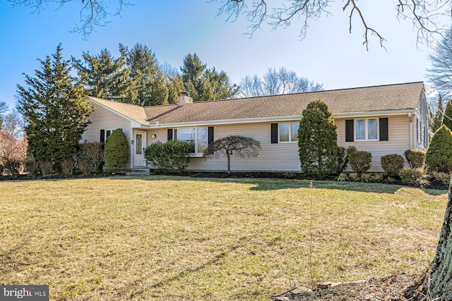 ranch-style house featuring a front lawn and a chimney