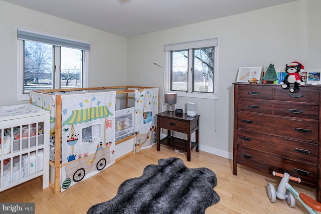 bedroom with baseboards and wood finished floors