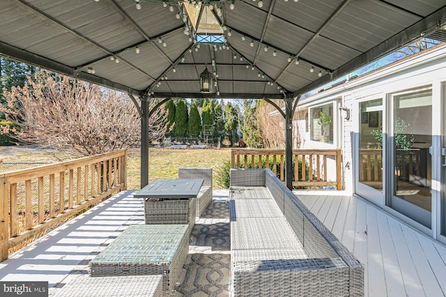 wooden terrace featuring a gazebo