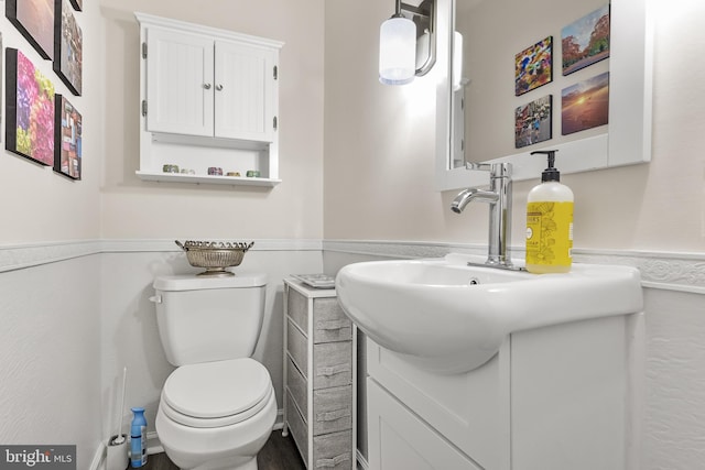 bathroom featuring toilet and vanity