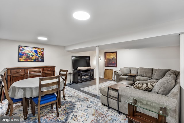 living room with baseboards and a fireplace