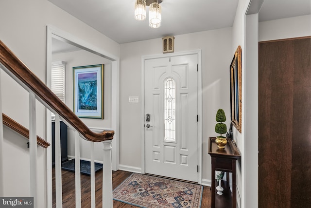 entrance foyer with baseboards, wood finished floors, and stairs