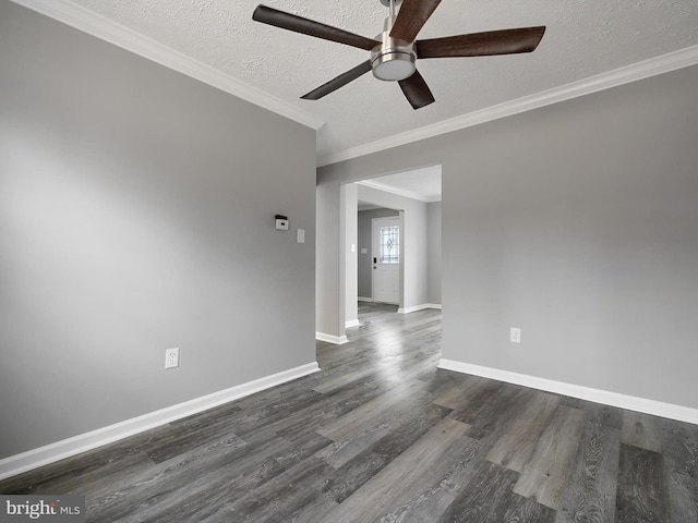 empty room with dark wood finished floors, a textured ceiling, ceiling fan, and ornamental molding