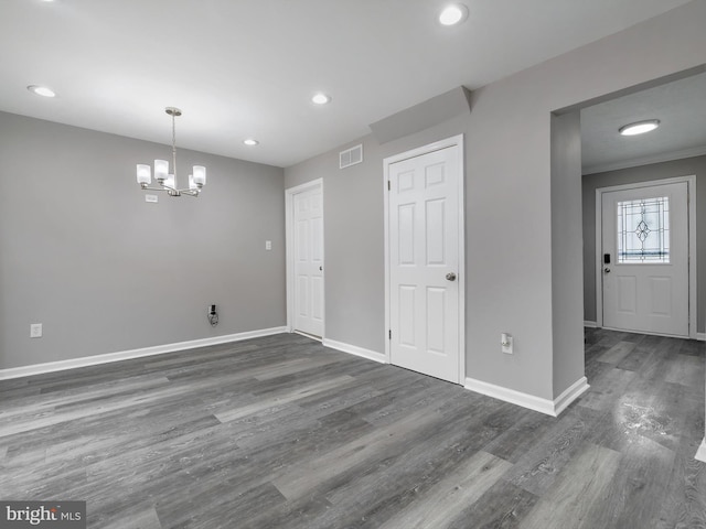 interior space with baseboards, visible vents, recessed lighting, dark wood-style flooring, and a notable chandelier