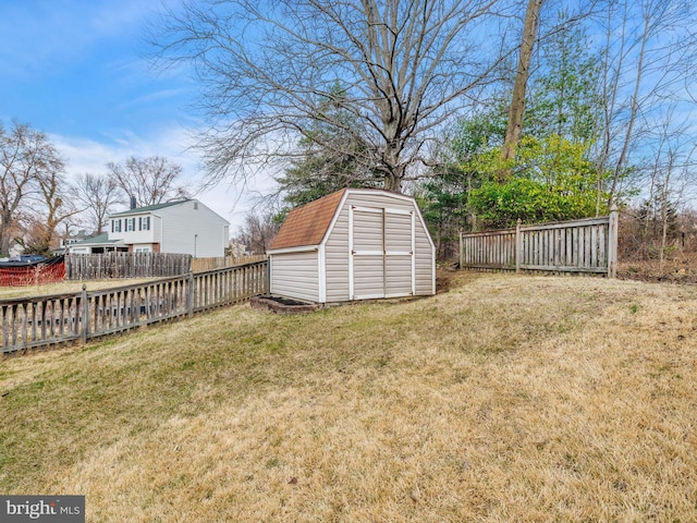 view of yard with a fenced backyard, a shed, and an outdoor structure