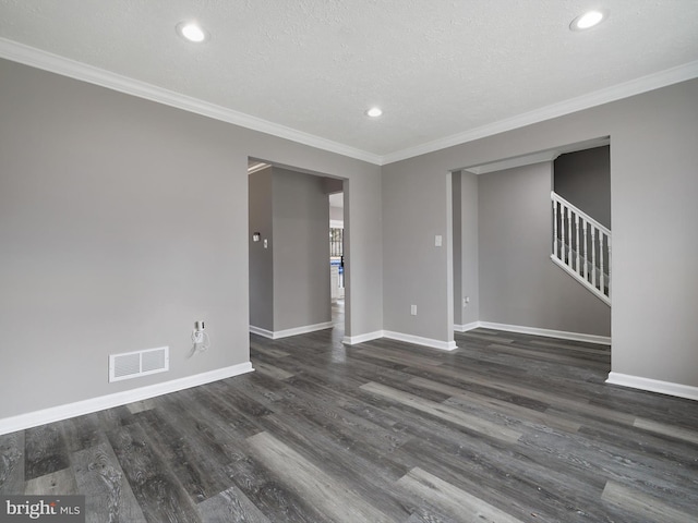 unfurnished room with visible vents, baseboards, and wood finished floors