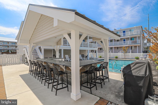 285 78th St, Avalon, NJ 08202 - view of patio / terrace featuring a grill, fence, and a community pool