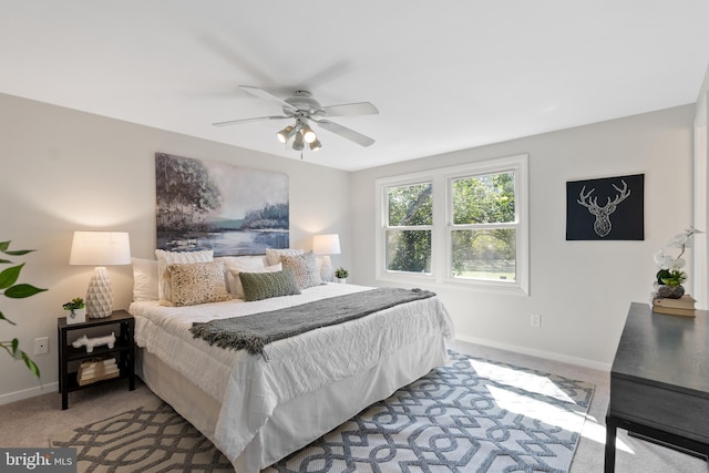 bedroom with carpet flooring, a ceiling fan, and baseboards