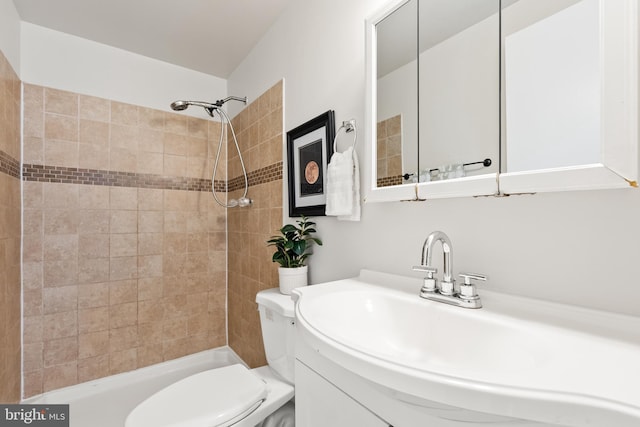 full bath featuring a tile shower, toilet, and vanity