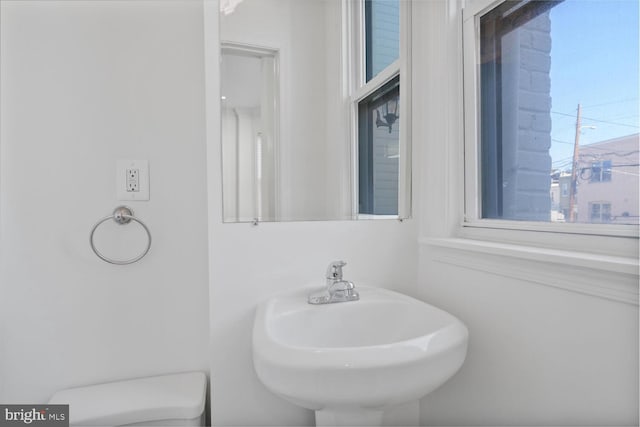 bathroom with toilet and a sink