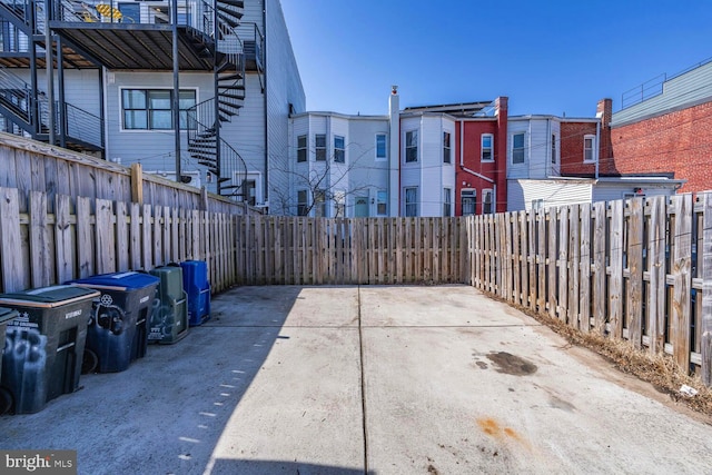 view of patio featuring stairs and a fenced backyard