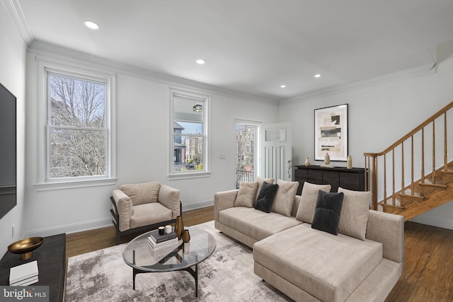 living room with stairway, wood finished floors, baseboards, and ornamental molding