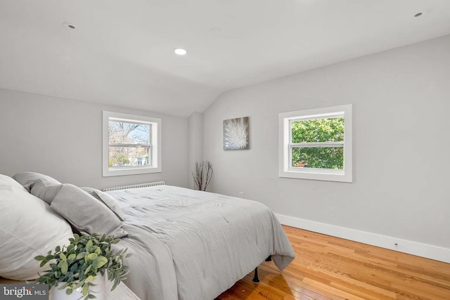 bedroom featuring recessed lighting, baseboards, wood finished floors, and vaulted ceiling