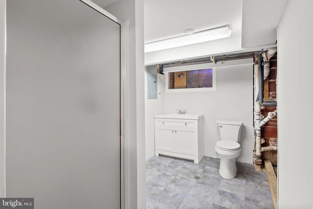 full bathroom featuring toilet, vanity, and a shower stall