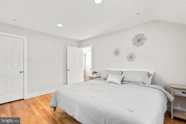 bedroom with recessed lighting, baseboards, light wood-style floors, and vaulted ceiling