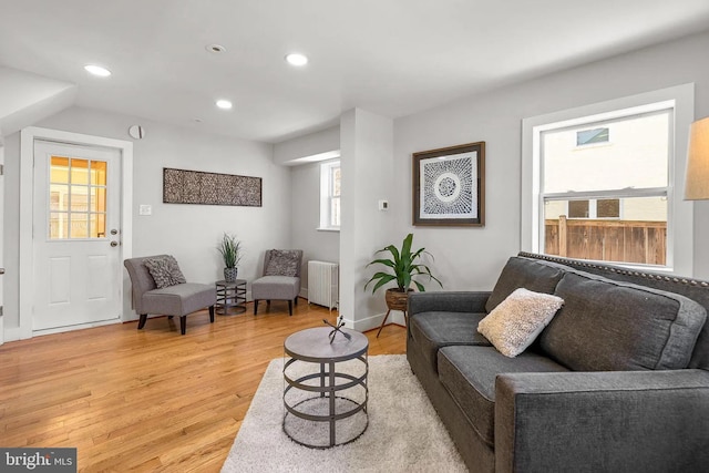 living room featuring radiator, recessed lighting, and light wood-type flooring