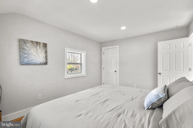 bedroom featuring recessed lighting, baseboards, wood finished floors, and vaulted ceiling