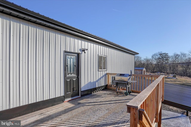 wooden terrace featuring grilling area