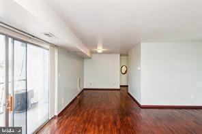 interior space with baseboards and wood finished floors