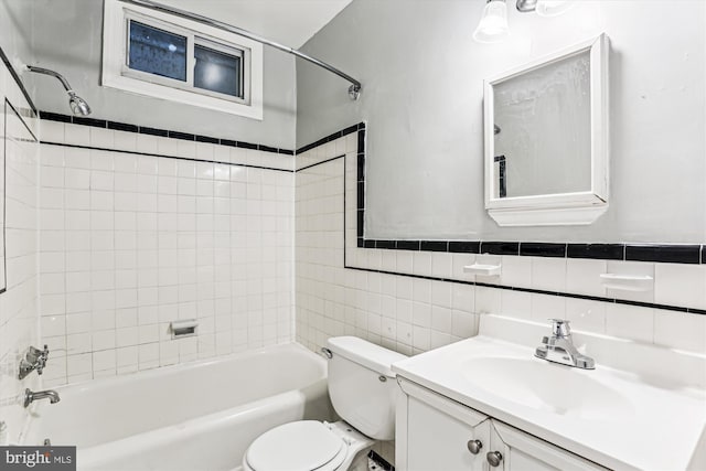 bathroom with bathing tub / shower combination, toilet, tile walls, and vanity