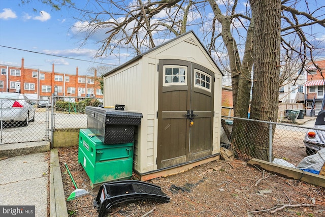 view of shed featuring a gate and fence