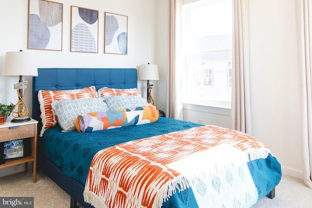 bedroom featuring carpet and baseboards