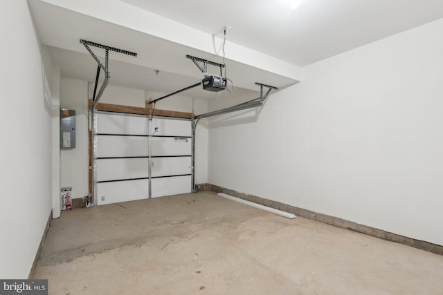 garage featuring electric panel, a garage door opener, and baseboards