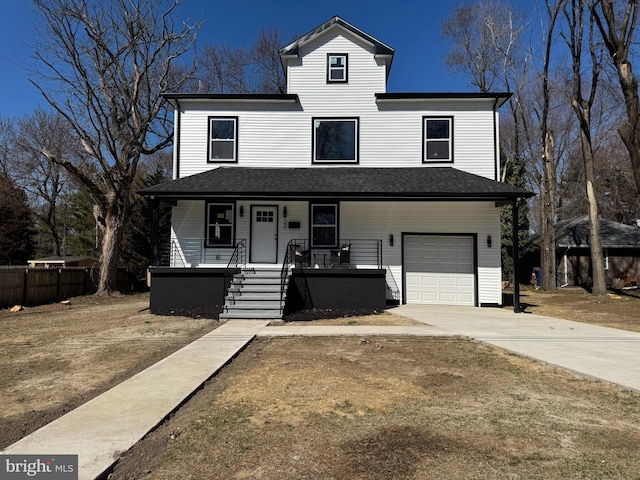 traditional-style house with a garage, a porch, concrete driveway, and fence