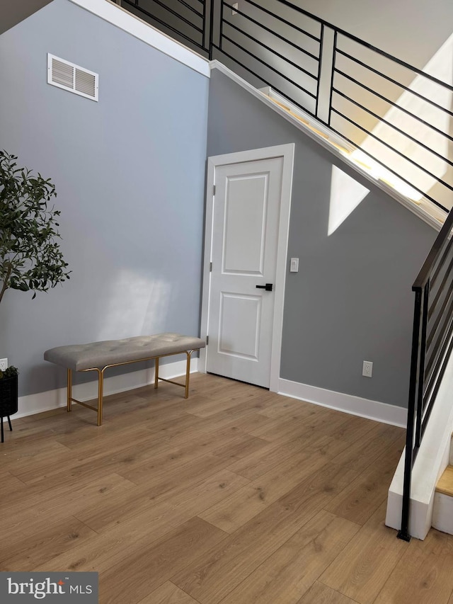 interior space with visible vents, baseboards, stairs, and light wood finished floors