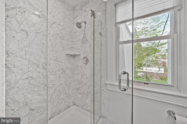 bathroom with a marble finish shower