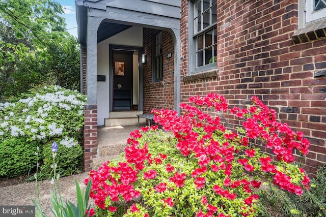 view of exterior entry with brick siding
