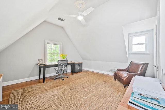 office area with visible vents, ceiling fan, vaulted ceiling, and wood finished floors