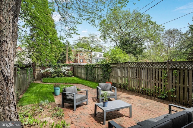 view of patio featuring an outdoor living space and a fenced backyard